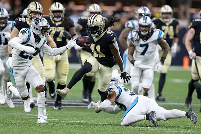Jan 2, 2022; New Orleans Saints running back Alvin Kamara (41) runs through the Carolina Panthers. Mandatory Credit: Chuck Cook-USA TODAY Sports